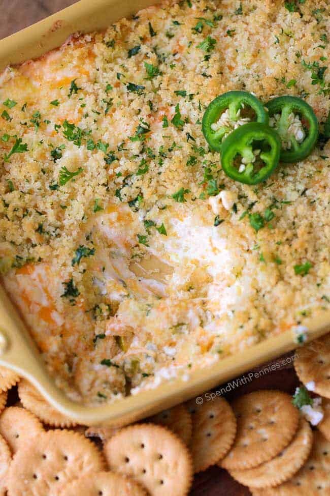 Jalapeno Popper Dip served with crackers and garnished with fresh jalapeno slices