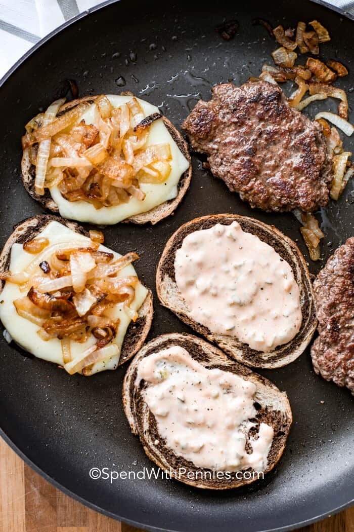 Homemade patty melts in a pan