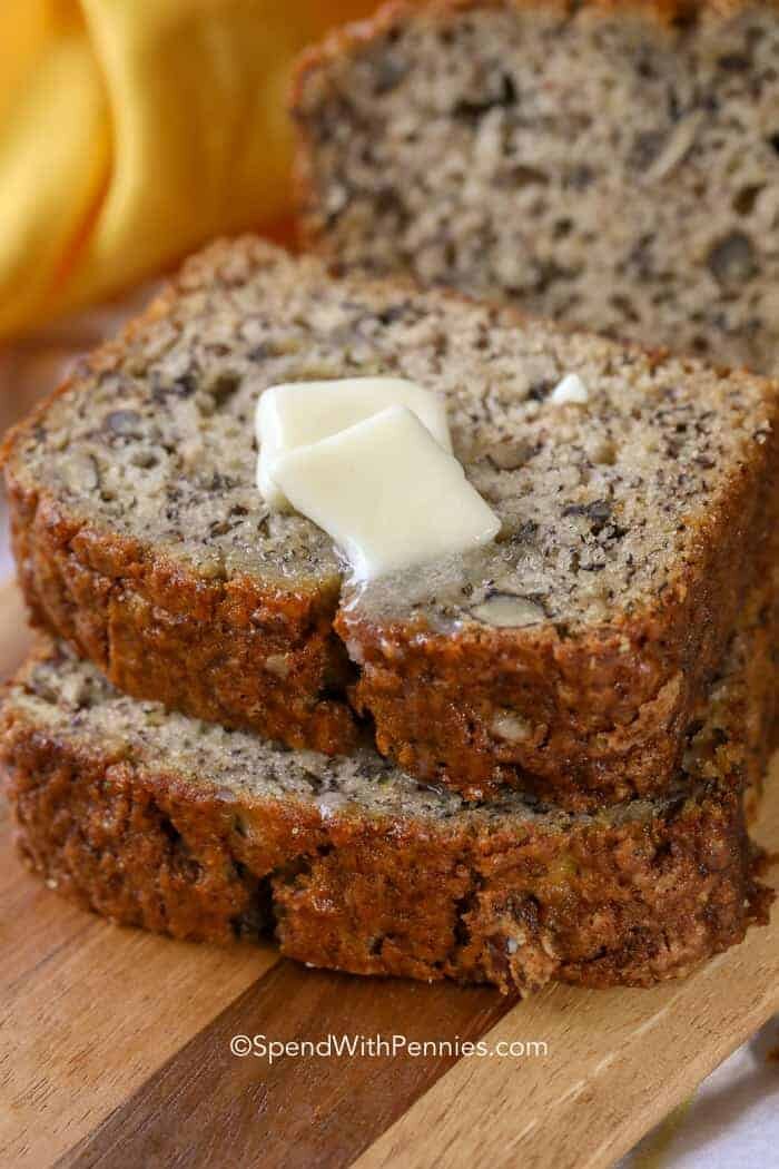 Two slices of banana bread with melting butter on top