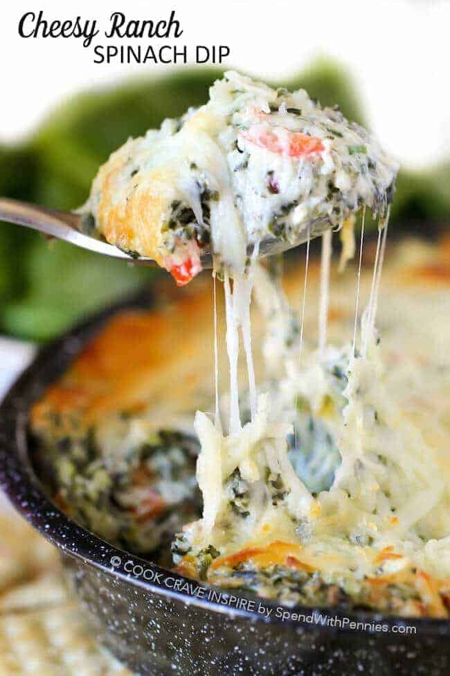 Cheesy Ranch Spinach Dip with a cheesy scoop being lifted out