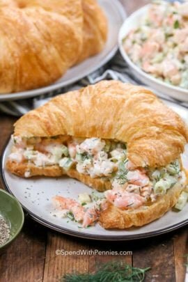 Shrimp Salad in a croissant on a white plate