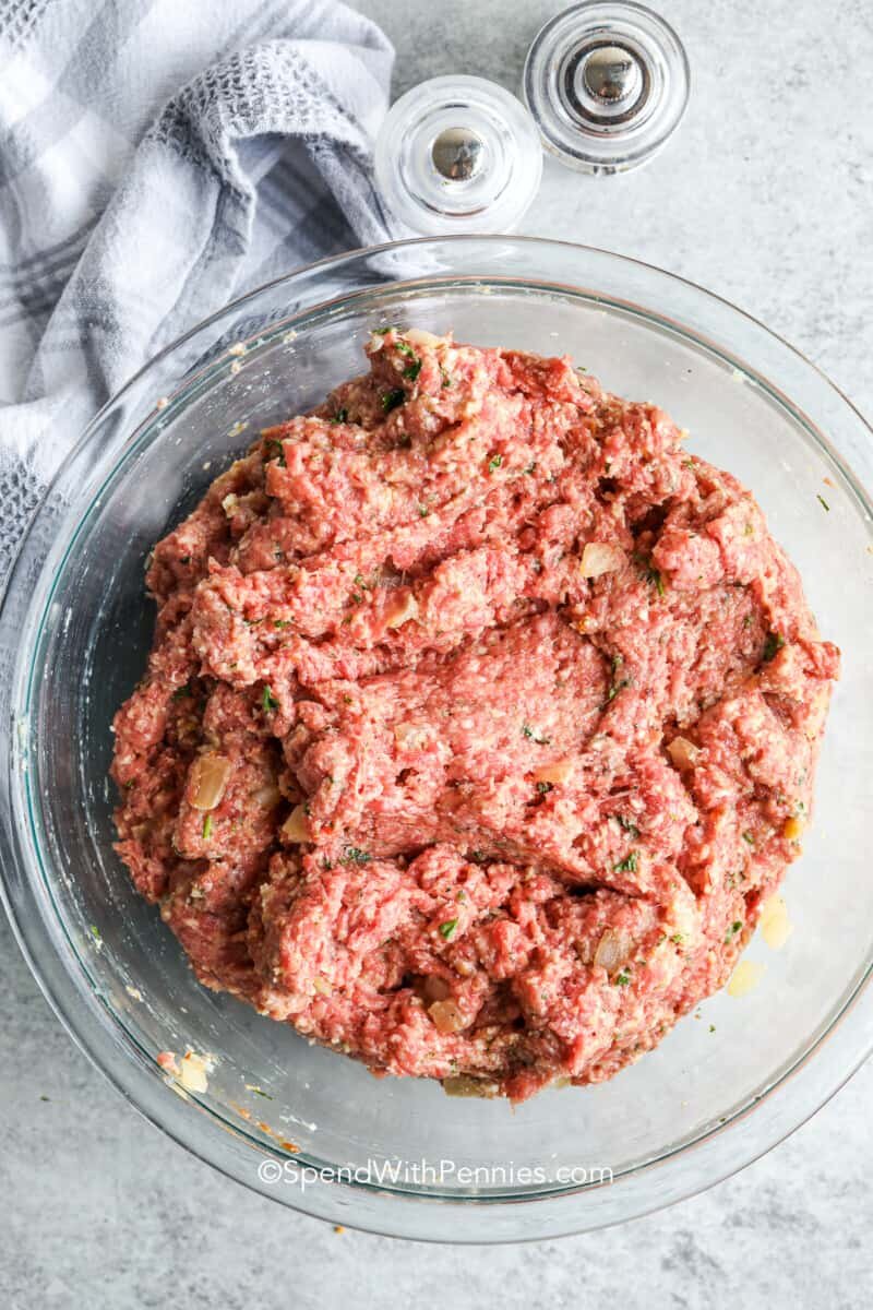 Mixed ingredients in a glass bowl for a classic homemade meatloaf recipe